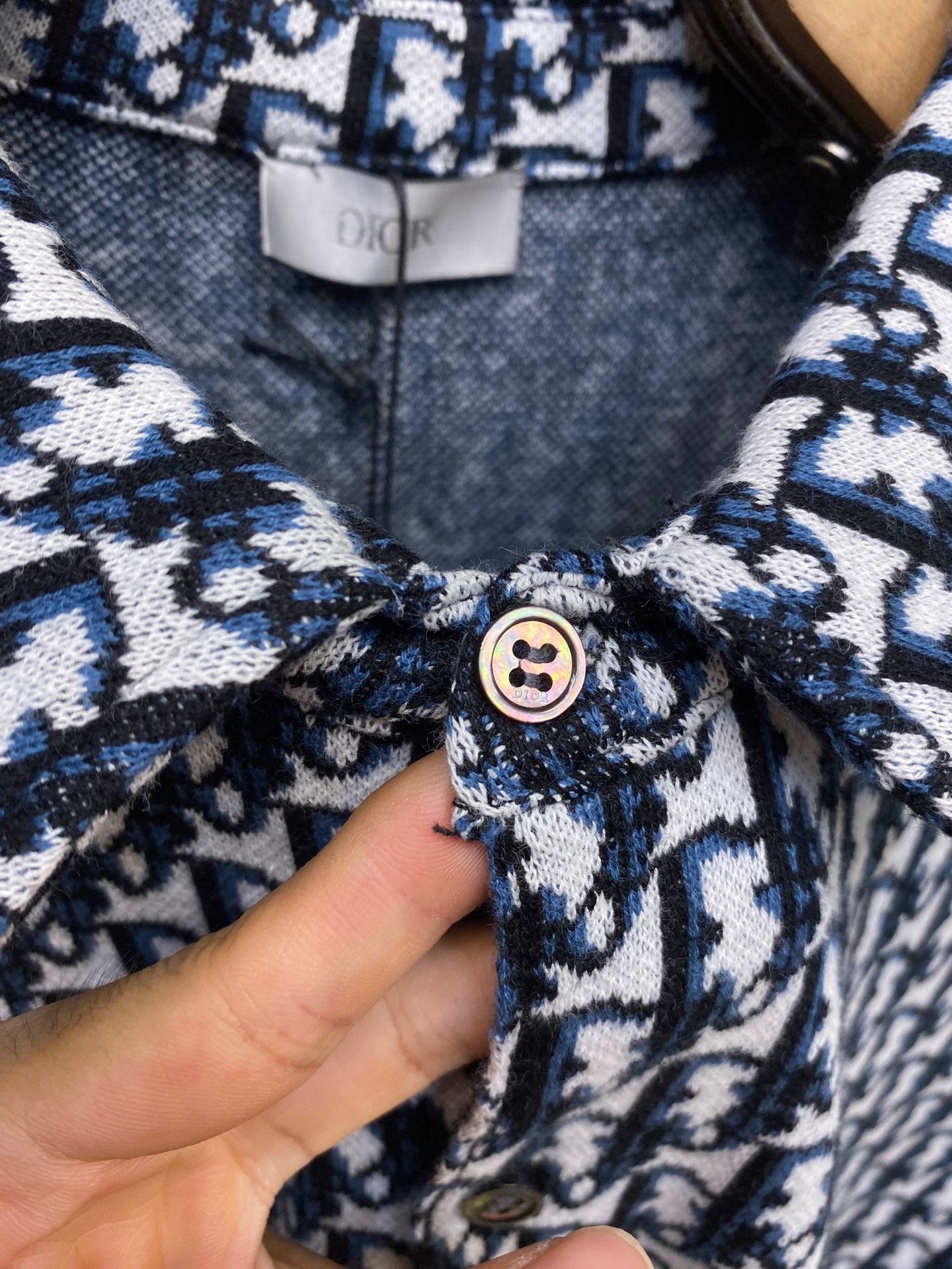 Navy and white patterned shirt front with round button