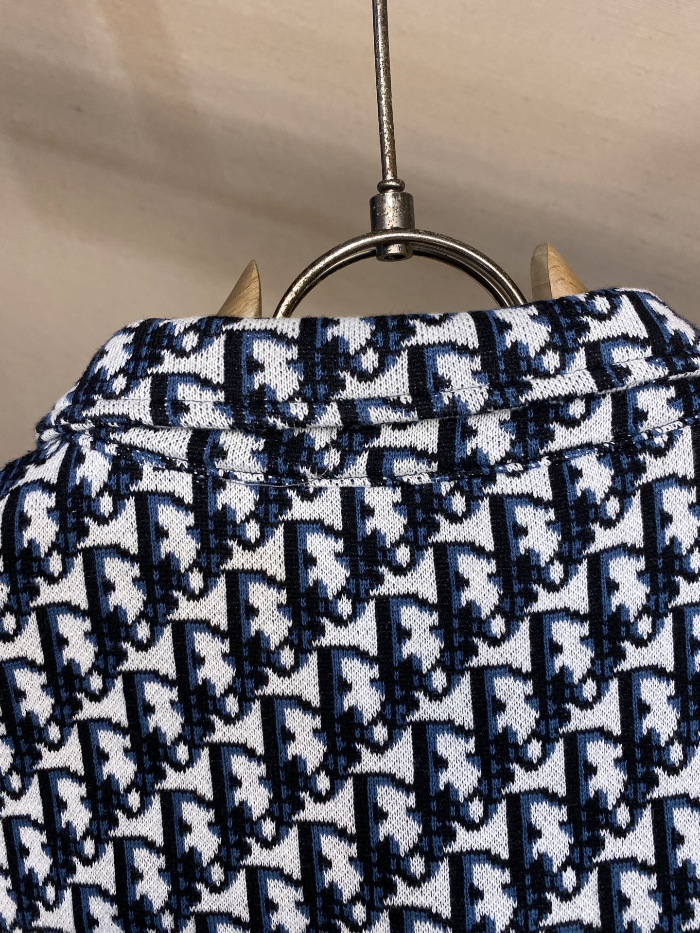 Navy and white patterned shirt back yoke on hanger