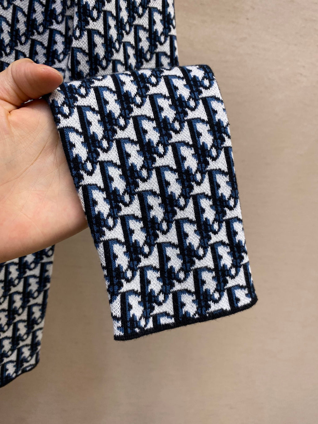 Navy and white patterned knit cuff section of long-sleeve shirt