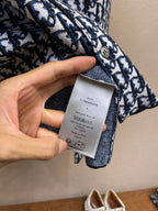 Navy and white patterned shirt with size and care tag