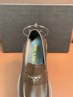 Prada unisex loafer with dark metallic brown leather upper and visible interior logo