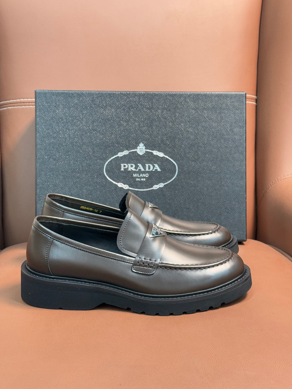 Prada unisex penny loafers in dark metallic brown leather with strap detail