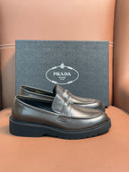 Prada unisex penny loafers in dark metallic brown leather with strap detail
