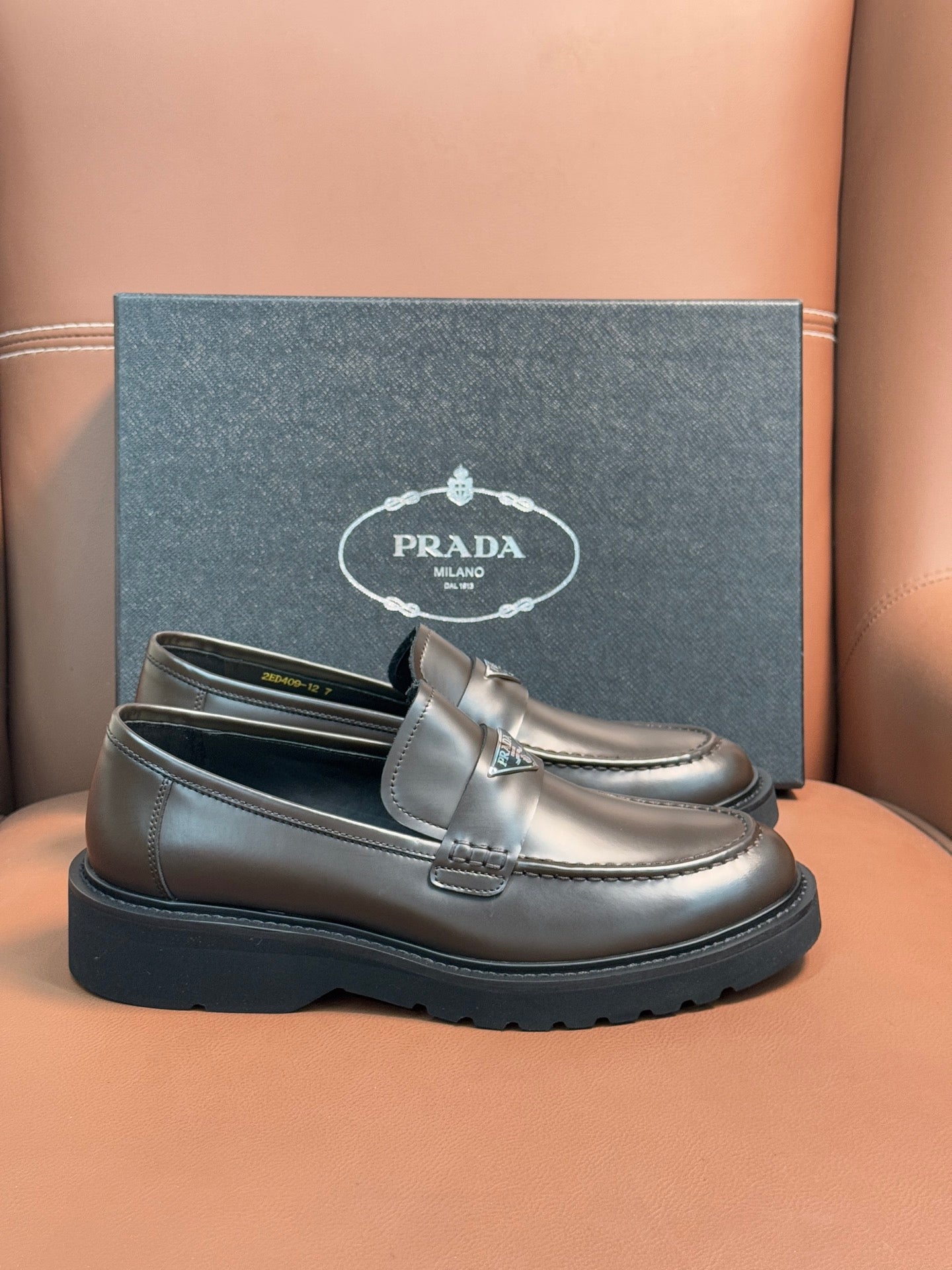 Prada unisex penny loafers in dark metallic brown leather with strap detail