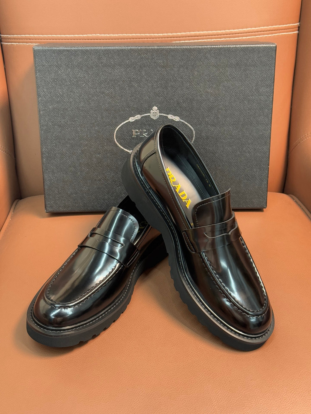 Prada unisex loafers in dark metallic leather, angled top view with slip-on vamp
