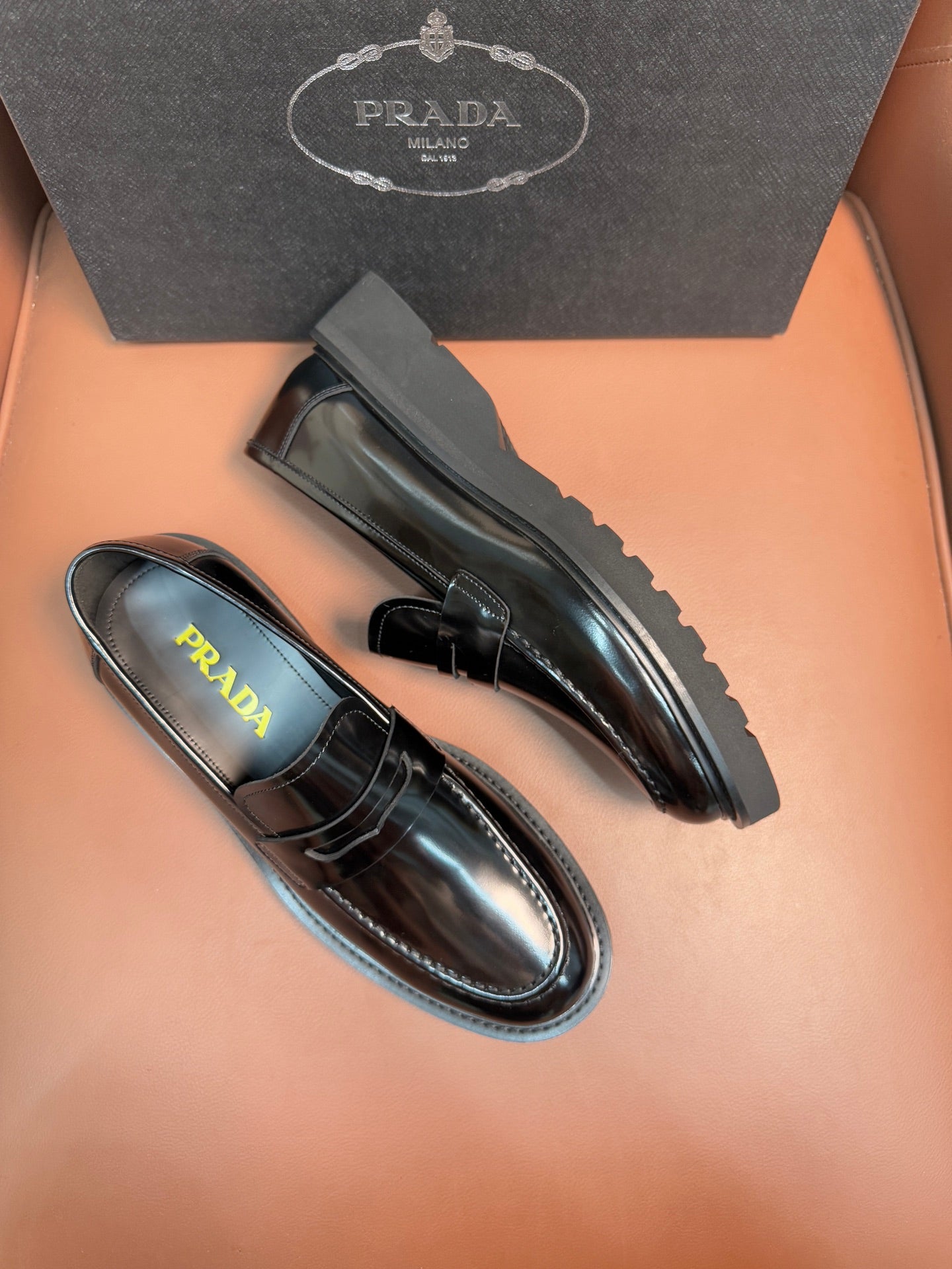 Prada unisex loafers, side view in dark metallic leather with strap and low profile
