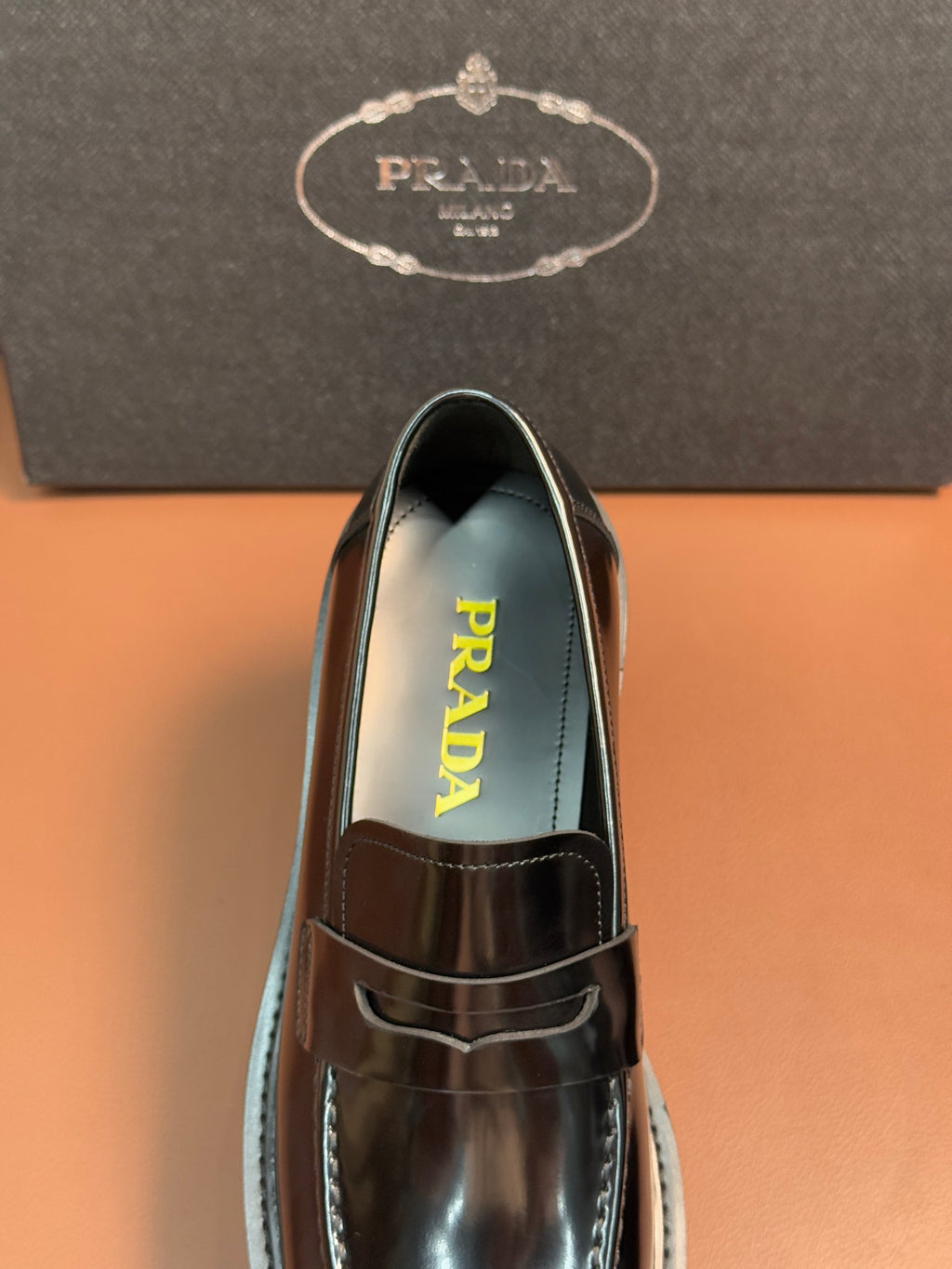 Prada unisex loafer, close-up of top and strap in dark metallic leather
