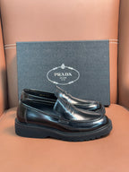 Prada unisex loafers in dark metallic leather, slip-on design with platform sole