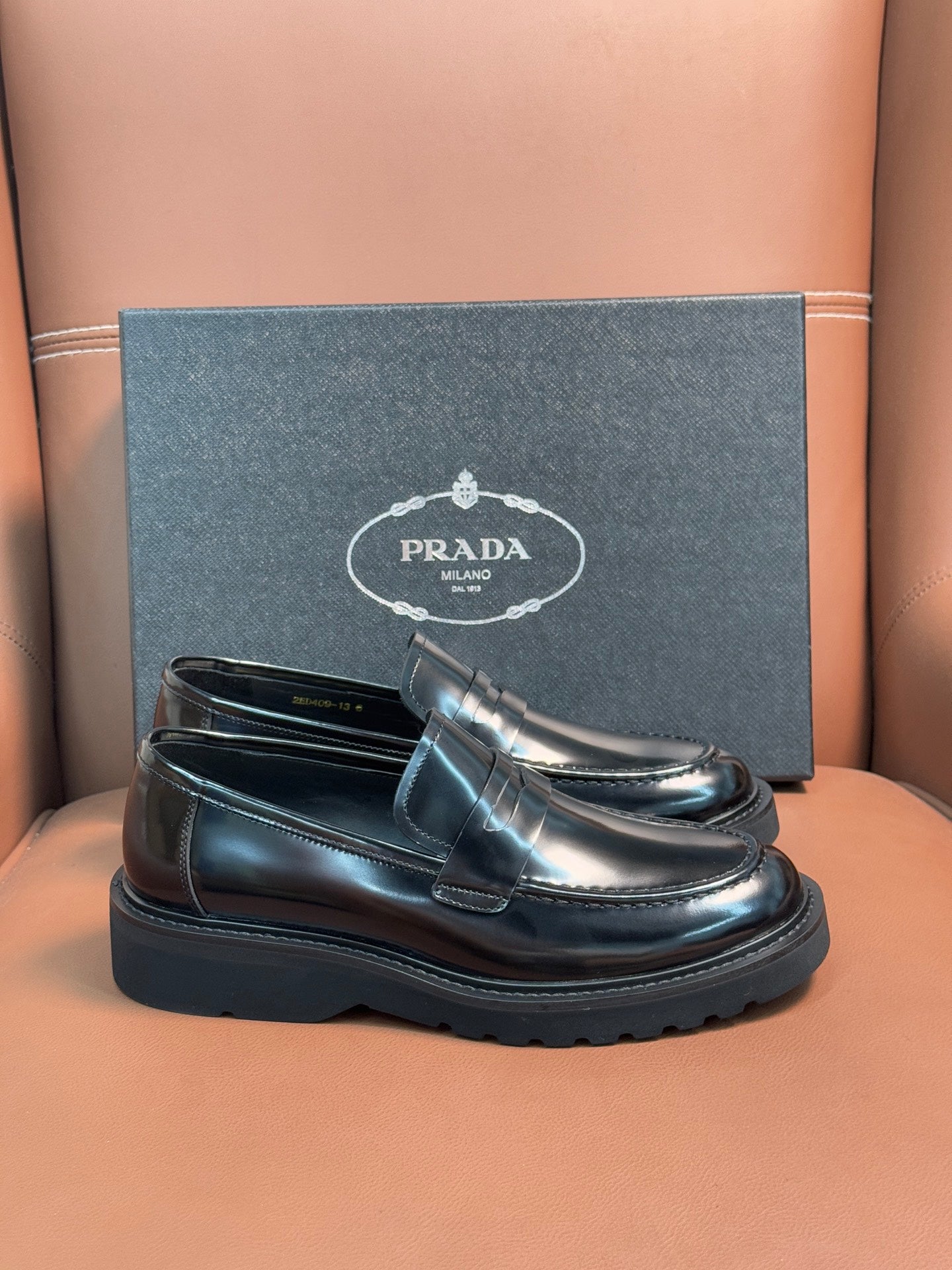 Prada unisex loafers in dark metallic leather, slip-on design with platform sole