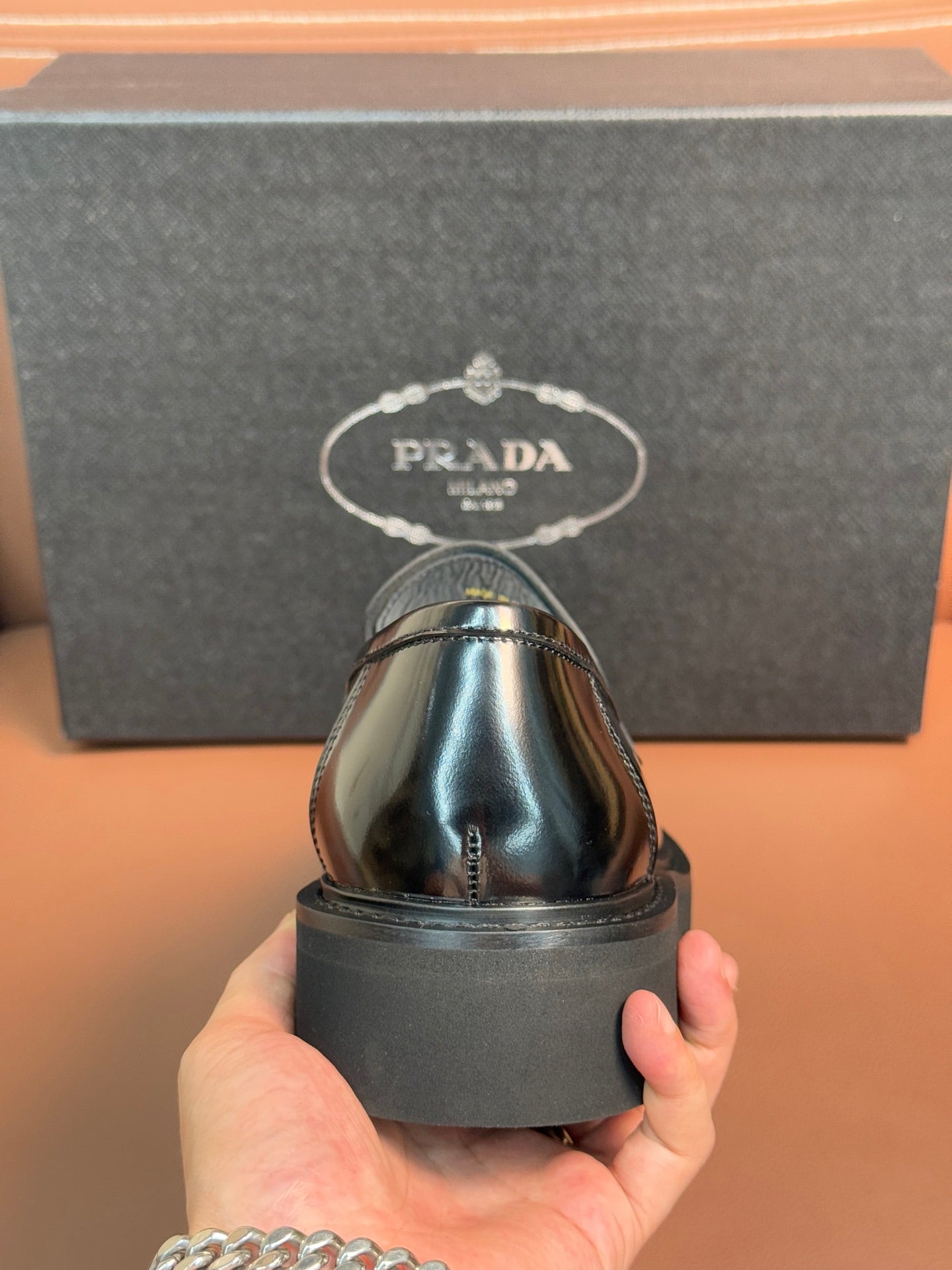 Prada unisex loafer heel view in dark metallic leather with platform sole