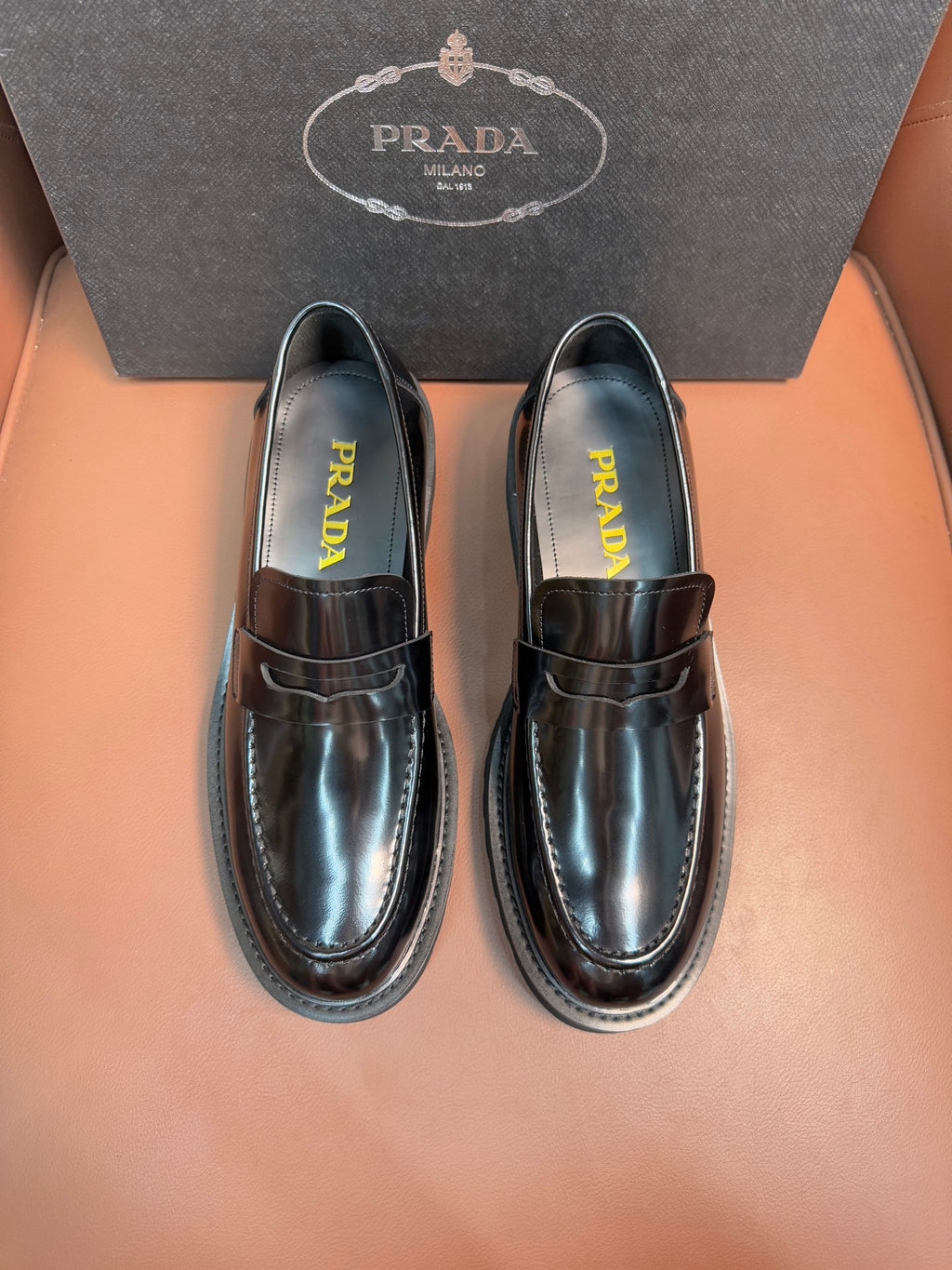 Prada unisex loafers in dark metallic leather, strap detail and stitched moc toe
