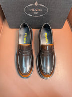 Dark metallic leather loafer with apron strap, stitched moc toe, chunky rubber sole