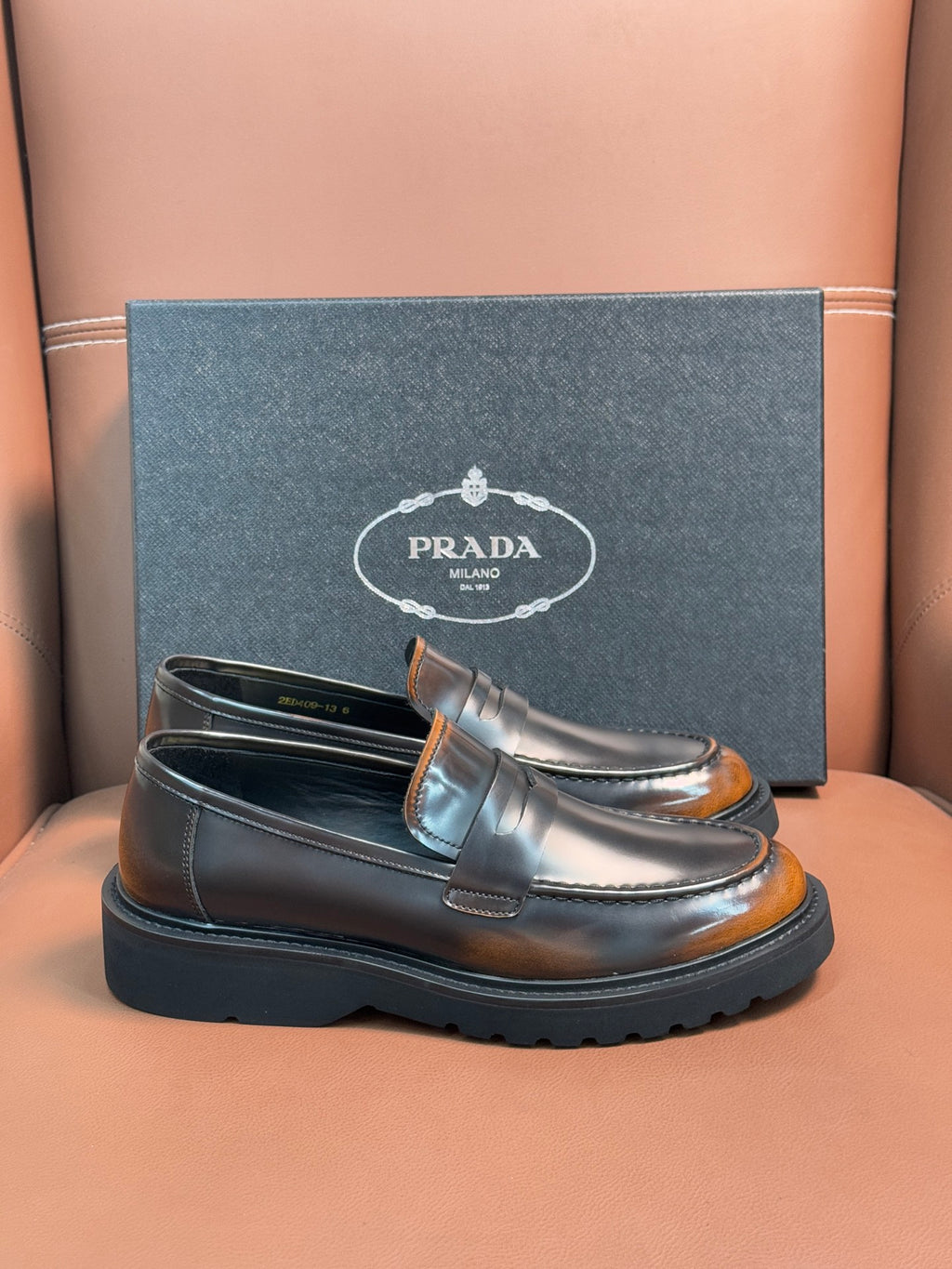 Dark metallic leather loafer with apron strap and stitched moc toe, chunky sole