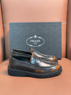 Dark metallic leather loafer with apron strap and stitched moc toe, chunky sole