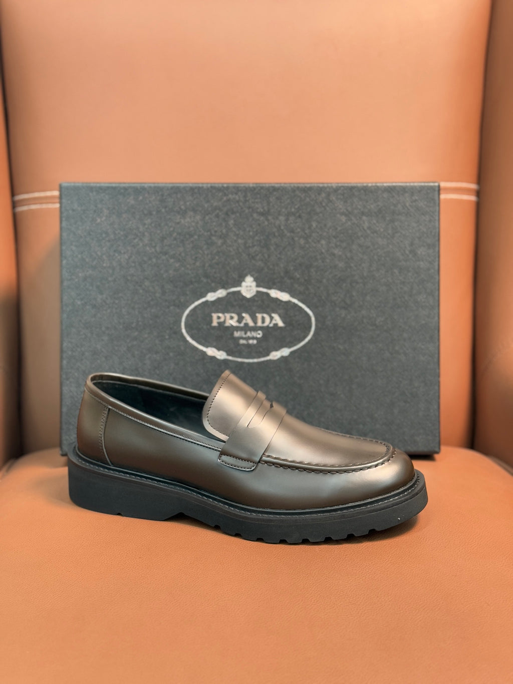 Metallic brown loafer with penny strap, stitched apron, black rubber sole