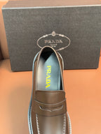 Metallic brown loafer with penny strap and Prada logo on insole lining