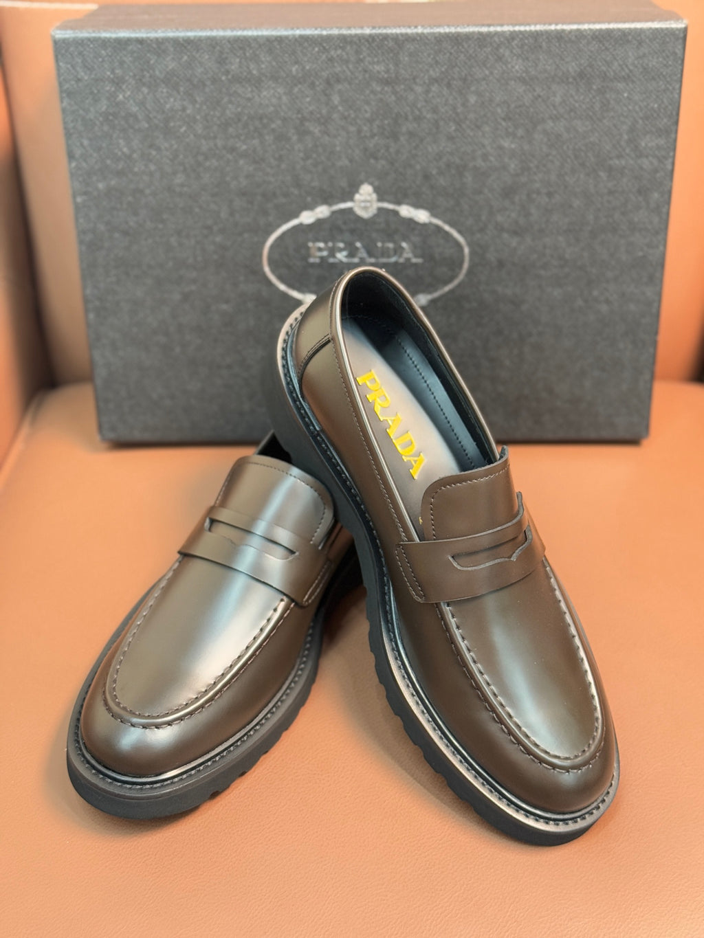 Metallic brown slip-on loafer with penny strap and Prada logo on lining