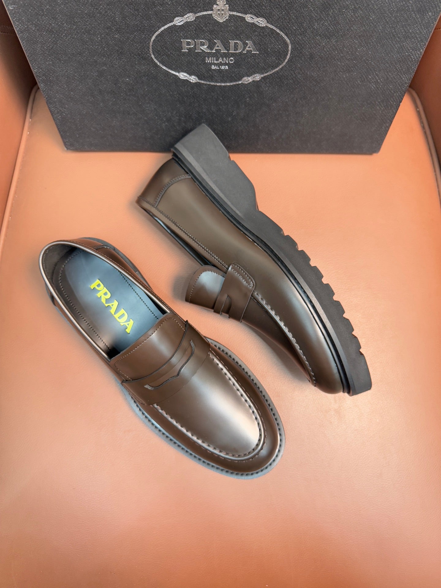 Metallic brown loafers, side profile with strap detail and contrast sole edge
