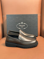 Metallic brown leather loafer with penny strap and thick black rubber sole