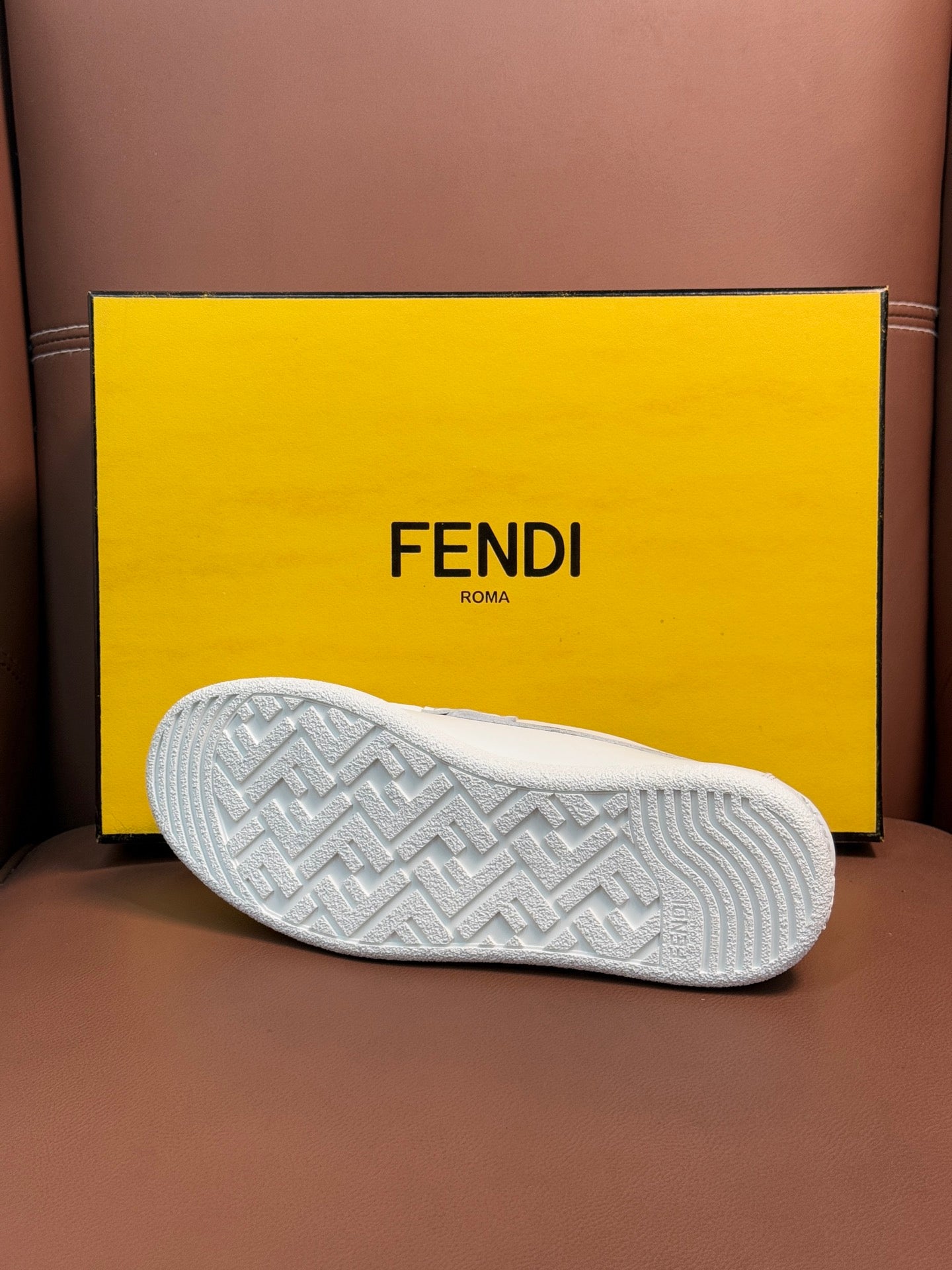 Fendi loafer outsole with textured tread pattern in white, on shoebox