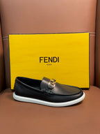 Fendi slip-on loafers in dark leather with gold buckle detail and white rubber sole