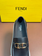 Fendi loafer in dark leather with gold buckle strap and FENDI logo on insole