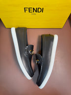 Fendi unisex loafers in dark leather with gold buckle strap and white rubber sole