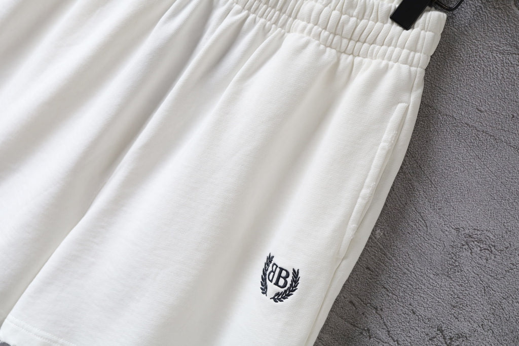 Balenciaga white shorts close-up with crest logo on leg