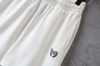 Balenciaga white shorts close-up with crest logo on leg