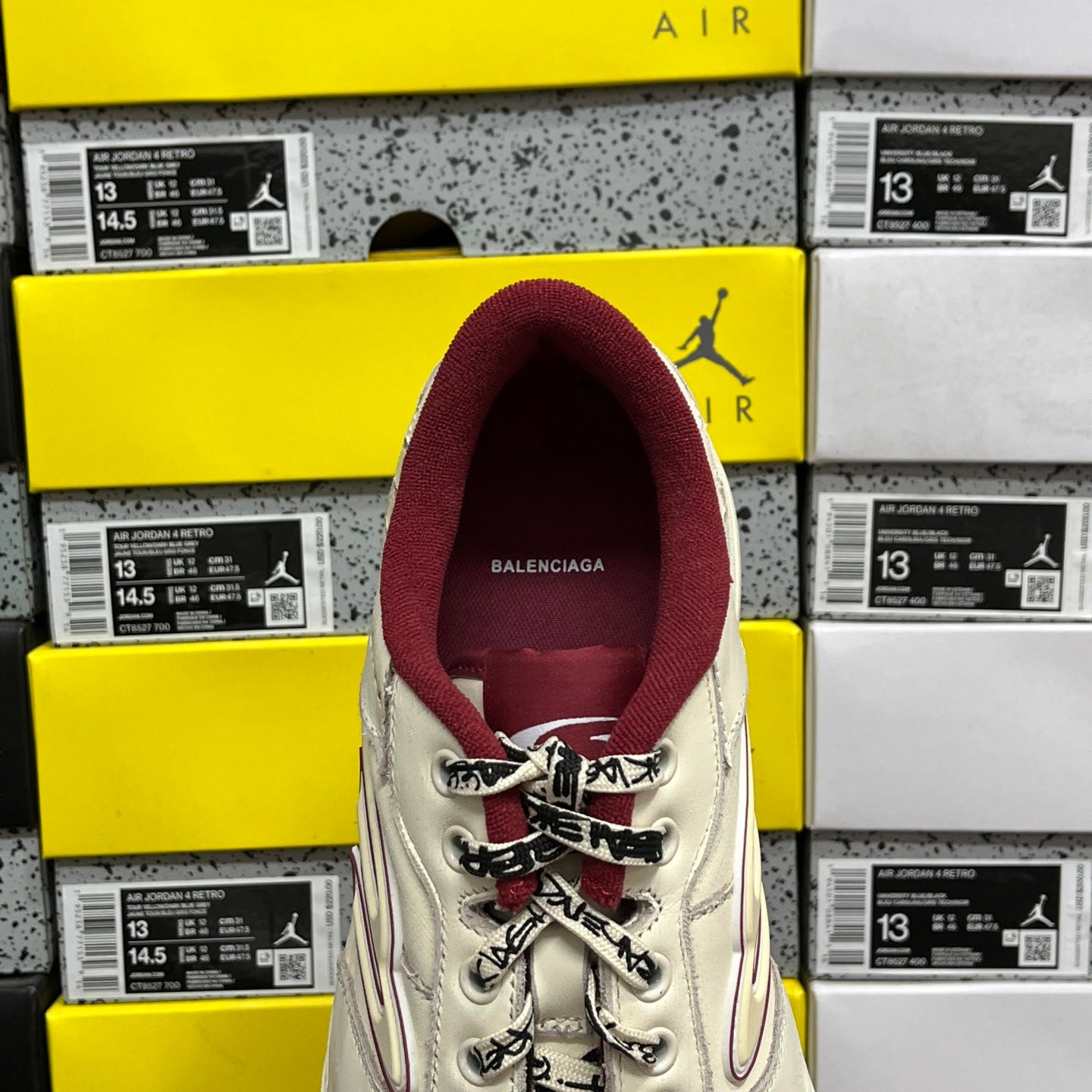 White Balenciaga sneaker with maroon heel lining, back view, lace-up top