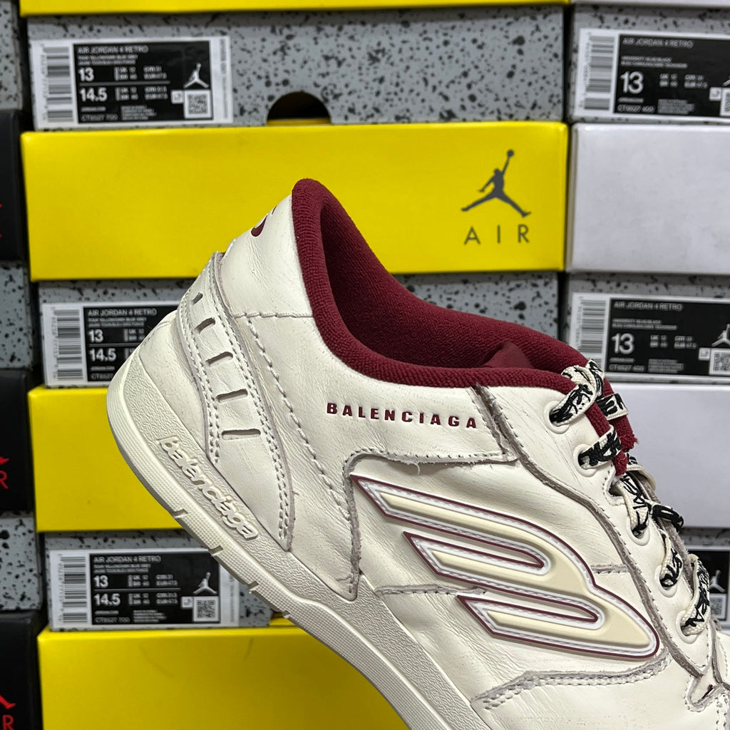 White Balenciaga sneaker with maroon inner lining and side logo, lace-up detail