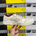 White Balenciaga low-top sneaker, maroon collar and interior, front side view