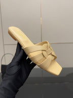 Women’s beige slide sandal, close-up of footbed and braided strap