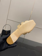 Women’s beige sandal outsole with molded traction, viewed from heel