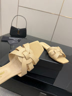 Beige slide sandals with braided cross straps, side view