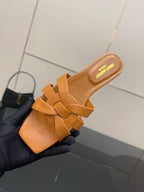 YSL women's orange woven slide sandal close-up, crossover straps and cushioned insole