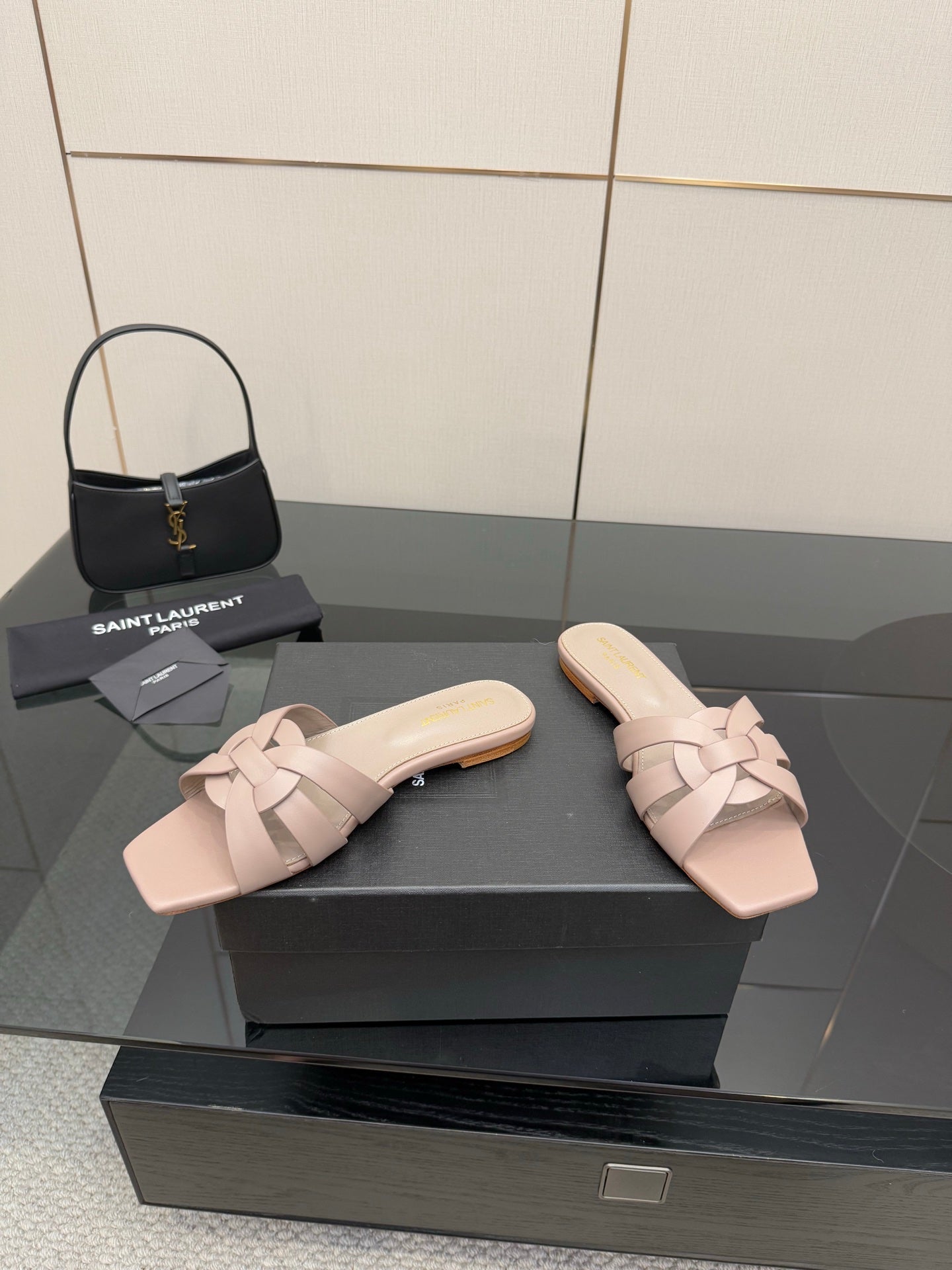 Women's light beige braided slide sandals on display, open toe