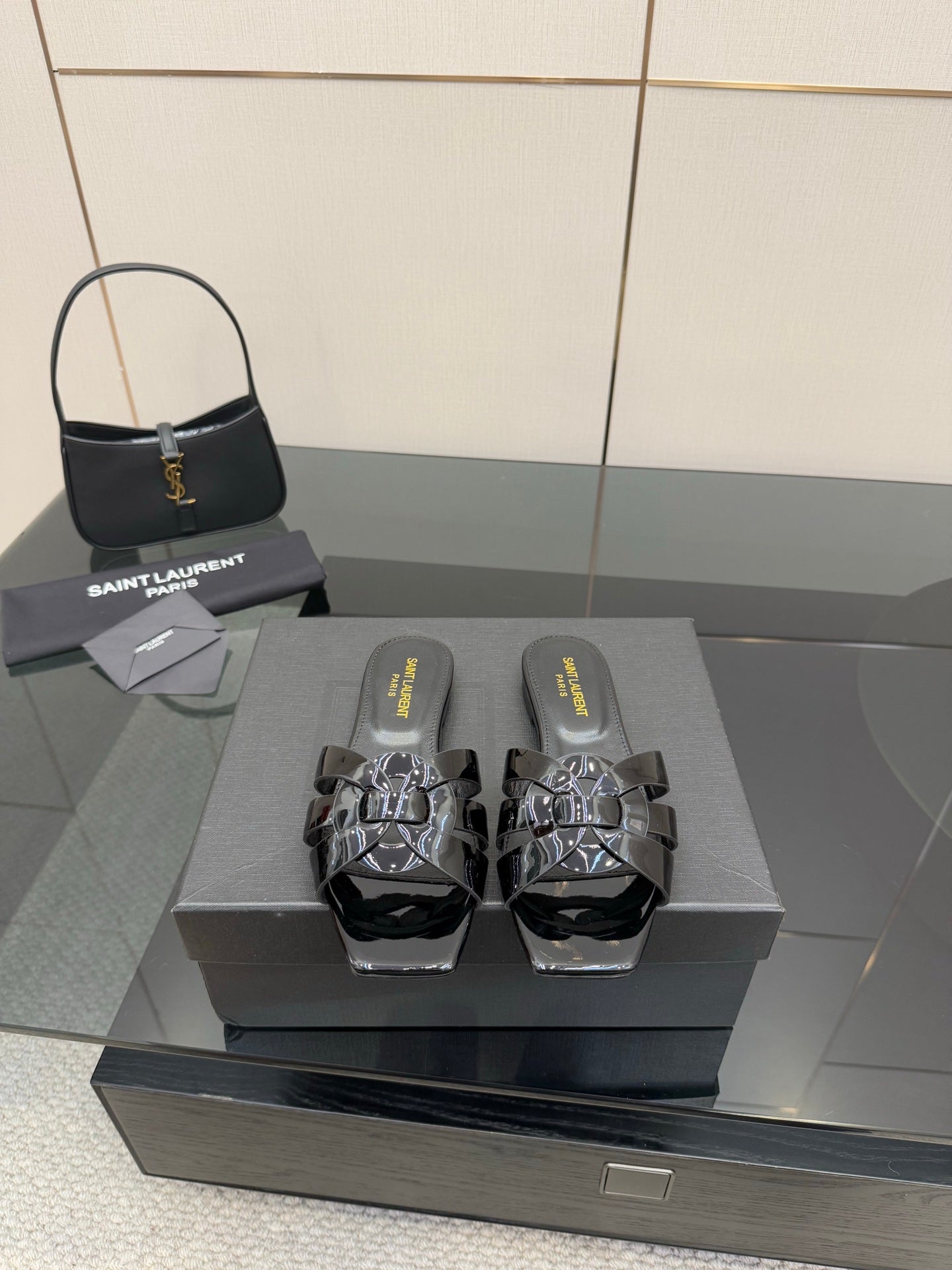 Black slide sandals with patent straps and metallic studded buckle detailing