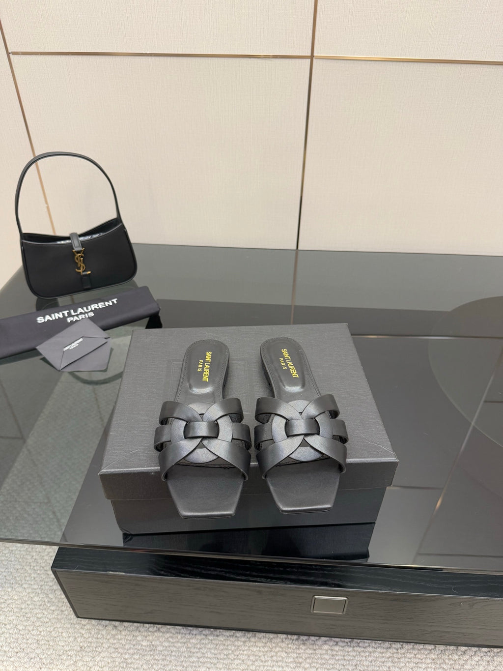 YSL ladies' slide sandals in dark material, braided strap across the top