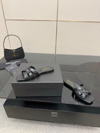 YSL ladies' slide sandals on box: dark braided straps, low flat outsole