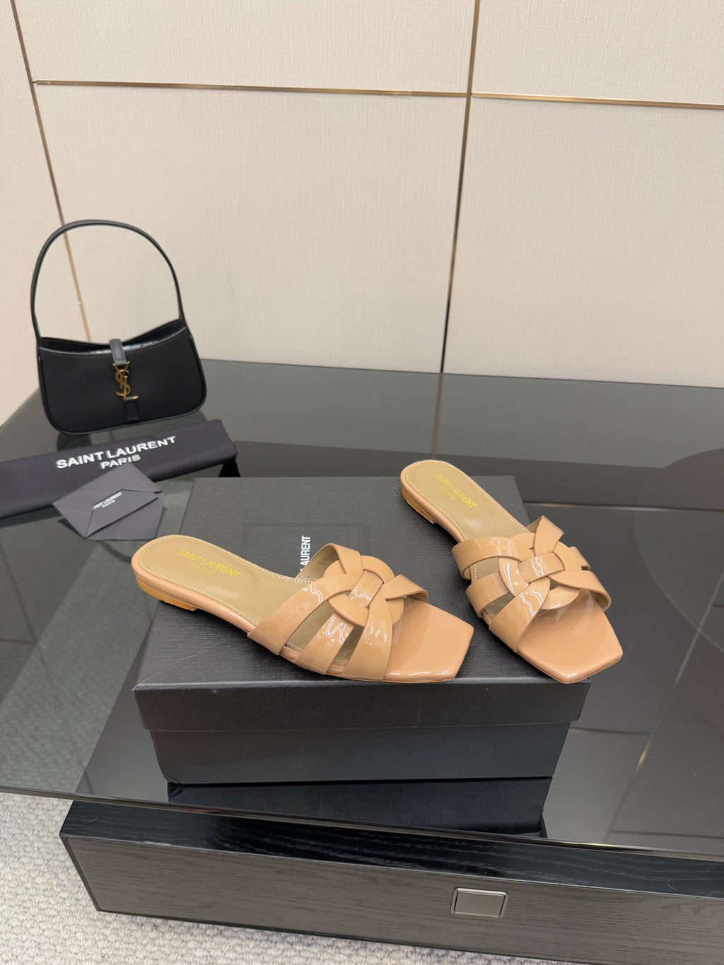 YSL ladies slide sandals pair on display, beige braided straps and low heel