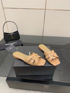 YSL ladies slide sandals pair on display, beige braided straps and low heel