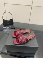 YSL pink bow mules, glossy open-toe slide sandals with stacked ribbon strap detail
