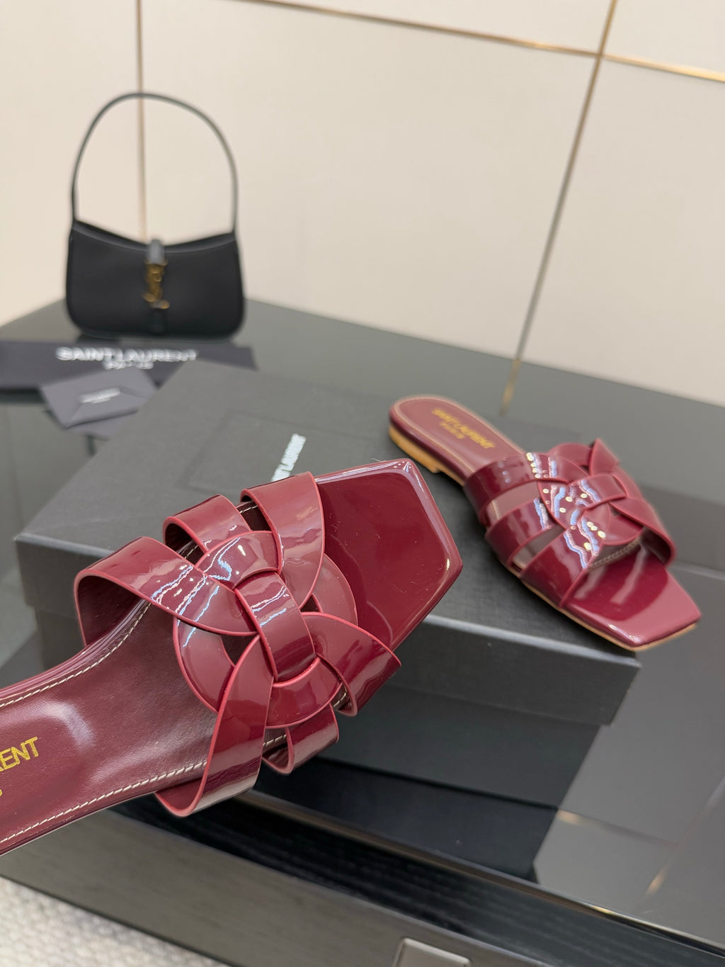 YSL pink patent bow mule close-up, open toe slide with layered bow straps and glossy finish