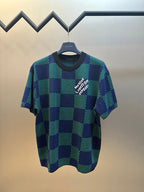 Blue and green check short-sleeve top with white graphic logo