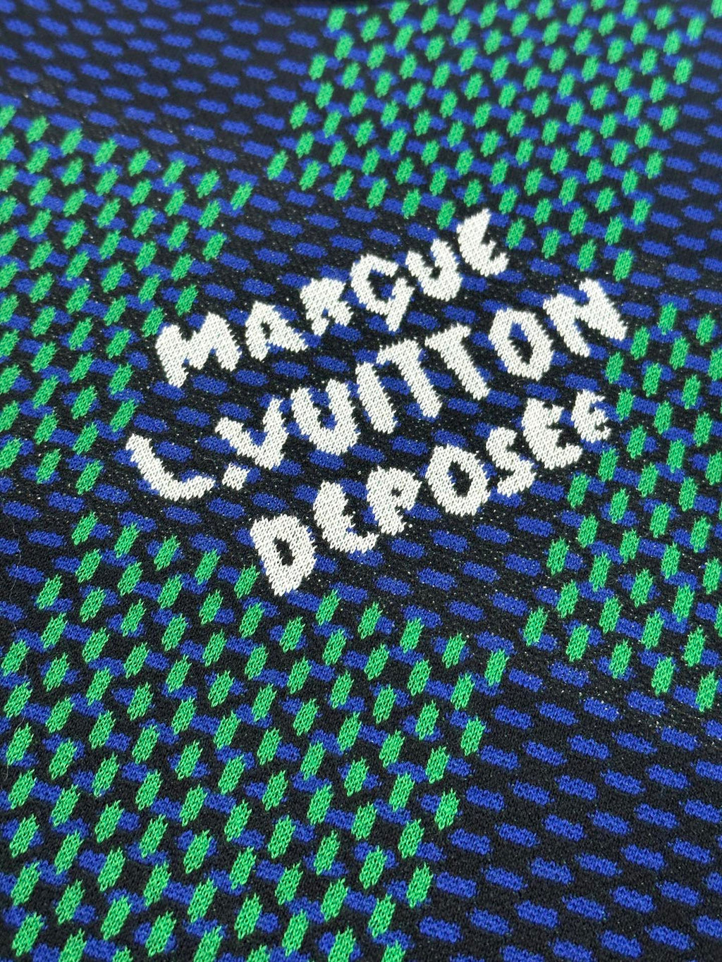 Louis Vuitton embroidered slogan on blue and green check T-shirt, white lettering on knit.