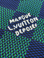 Louis Vuitton embroidered slogan on blue and green check T-shirt, white lettering on knit.