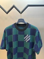Blue and green check short-sleeve top with white logo and black crew neck
