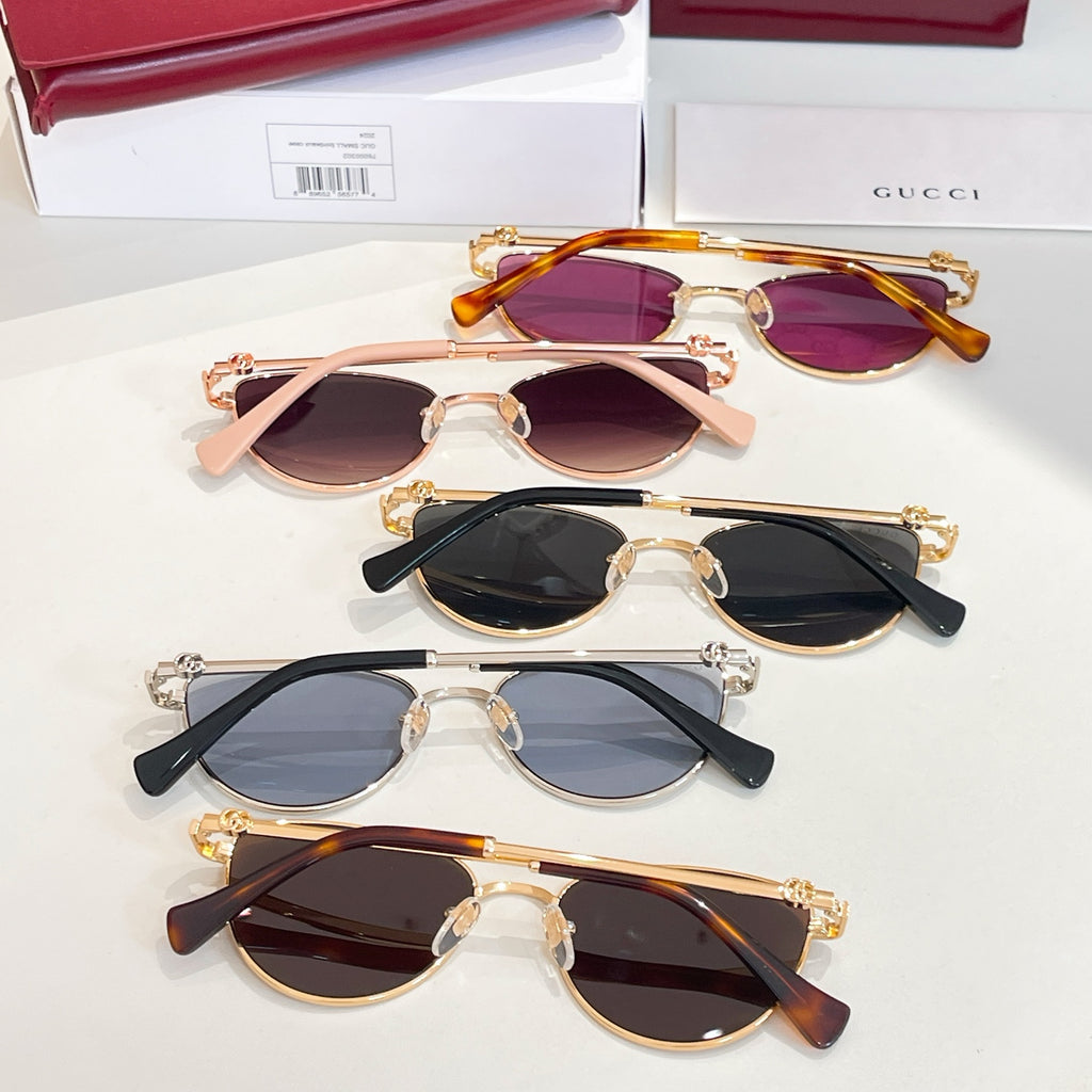 Sunglasses assortment with pink, purple, black, and dark lenses in gold frames.