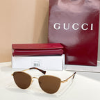 Sunglasses with gold frame and brown tinted lenses.